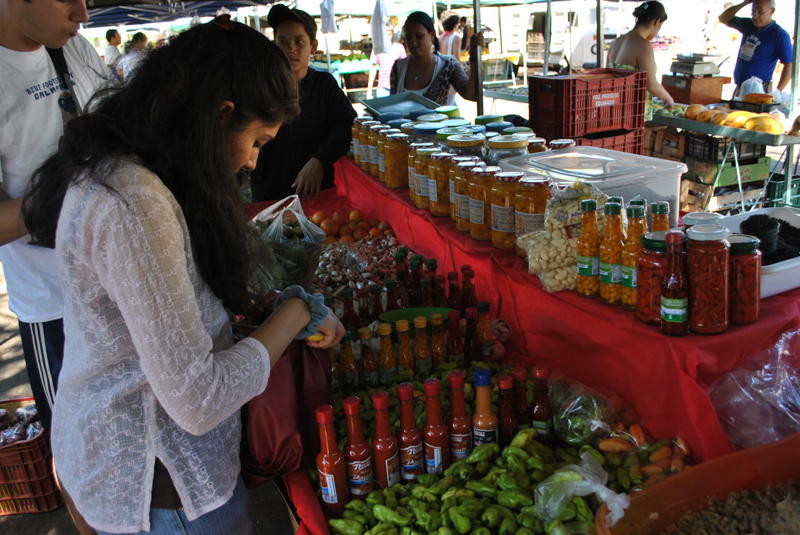 Sheela purchases chilies at the local farmers market
